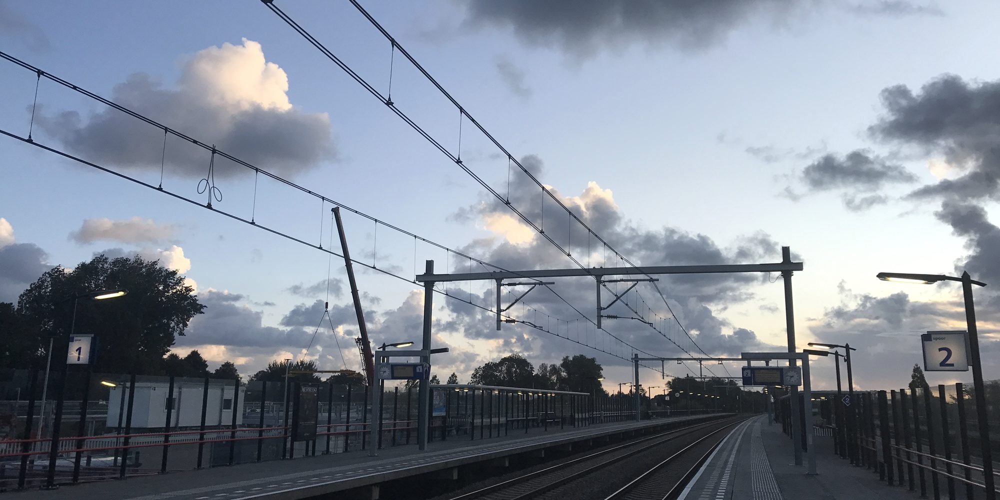 A real railway station under a big evening sky