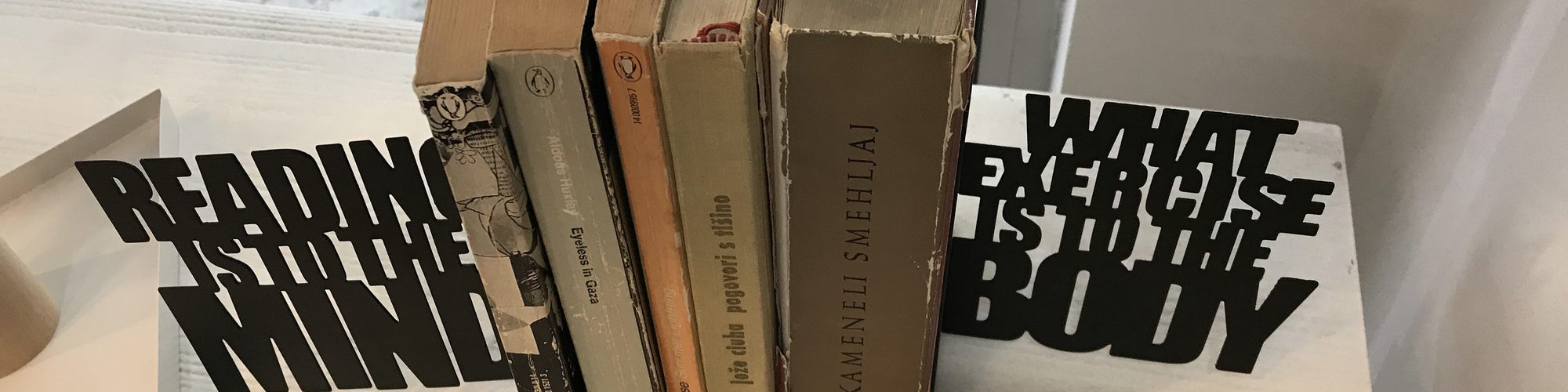 Old books between two bookends that read: Reading is to the mind what exercise is to the body
