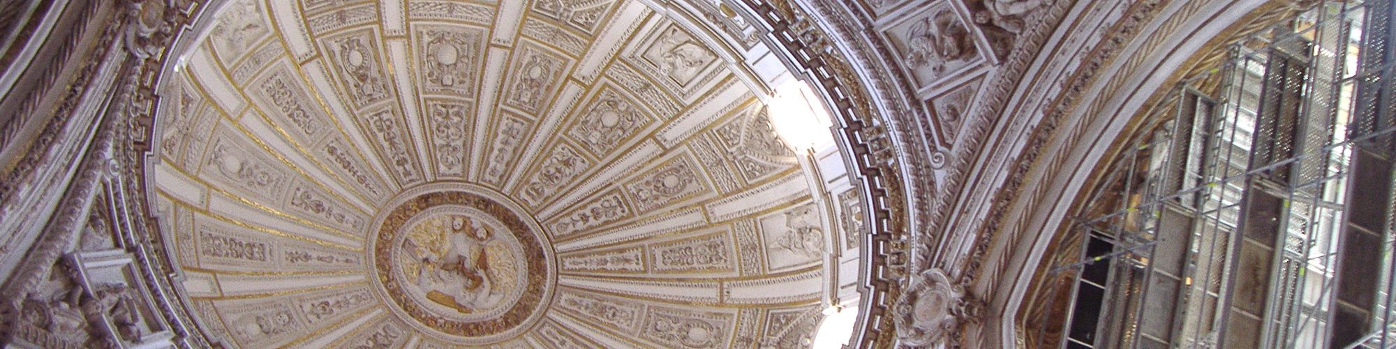 Looking up into a hand-made stucco dome, its ribs radiating from the centre