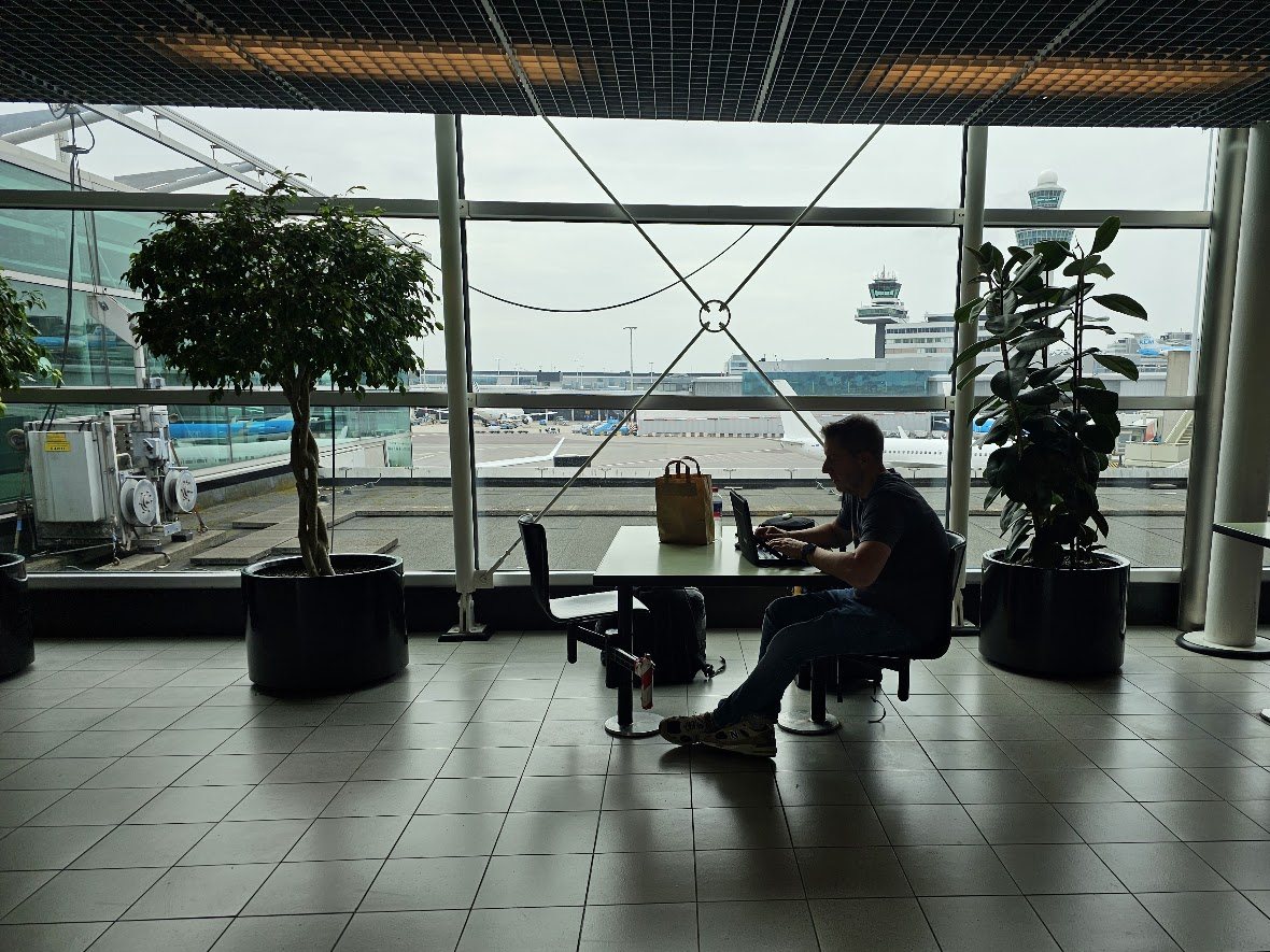 Jaco van der Laan working on a laptop at a window table; above him, drawn in line art, his life as data — photos, trips, books, health and finances — hangs from one structure that grows out of the laptop.