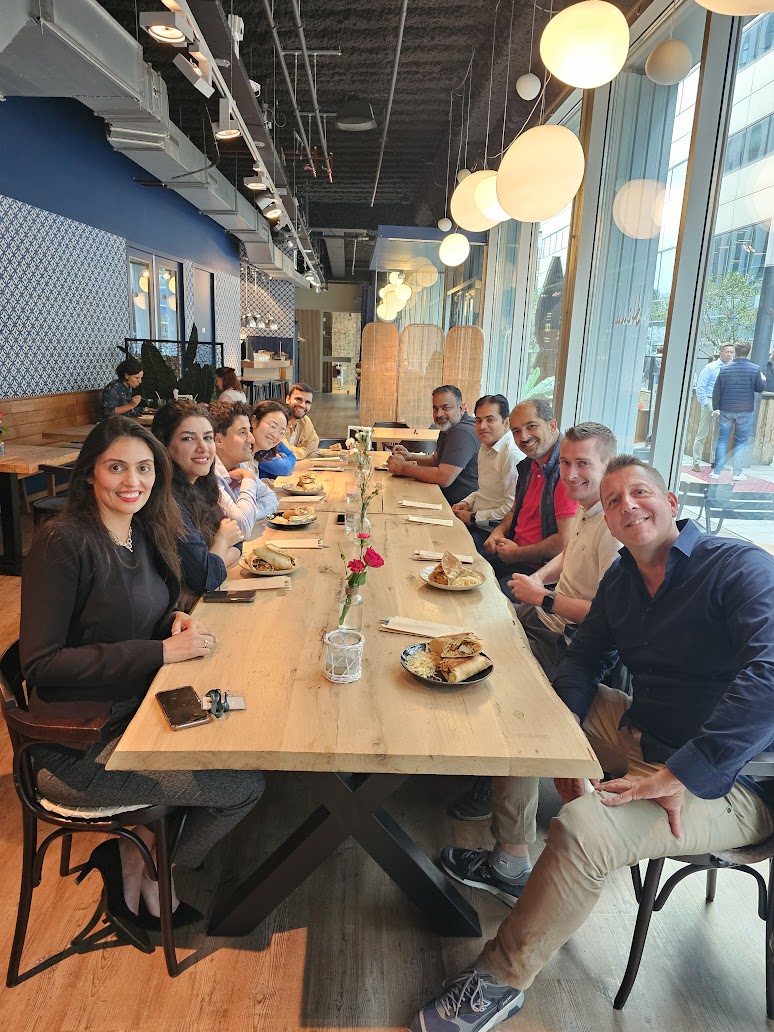 Jaco at a long dinner table with a data team