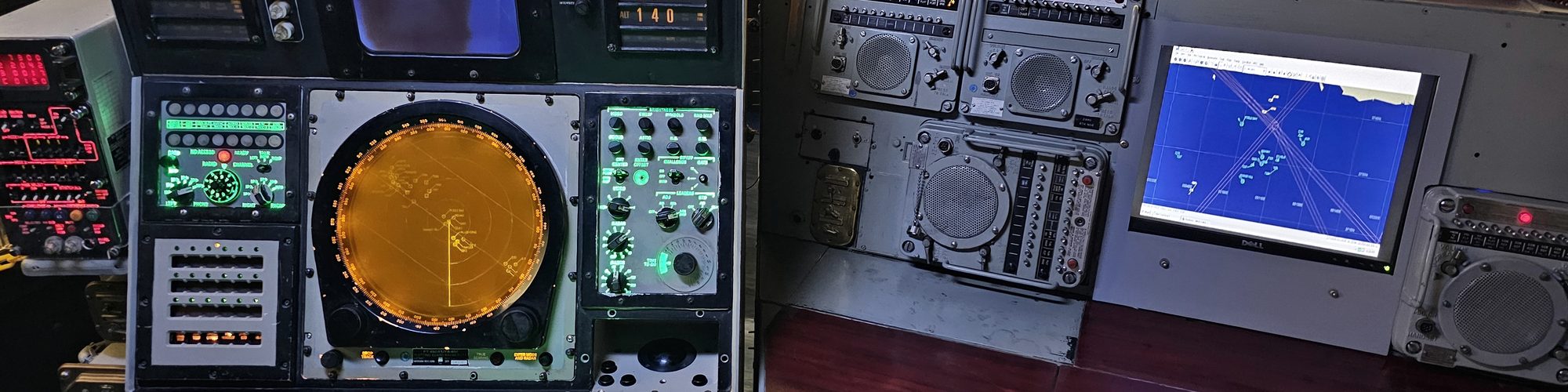 Radar screens, dials and switches on the control consoles of a museum ship: a system you can see working