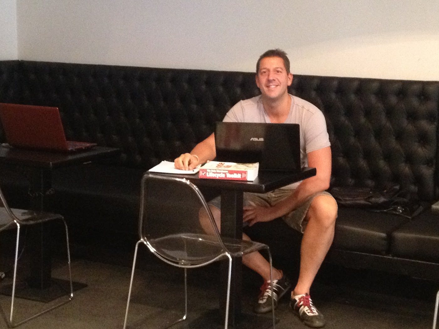 Jaco working from a laptop in a café